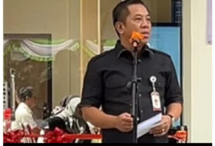 Man speaking at public event.