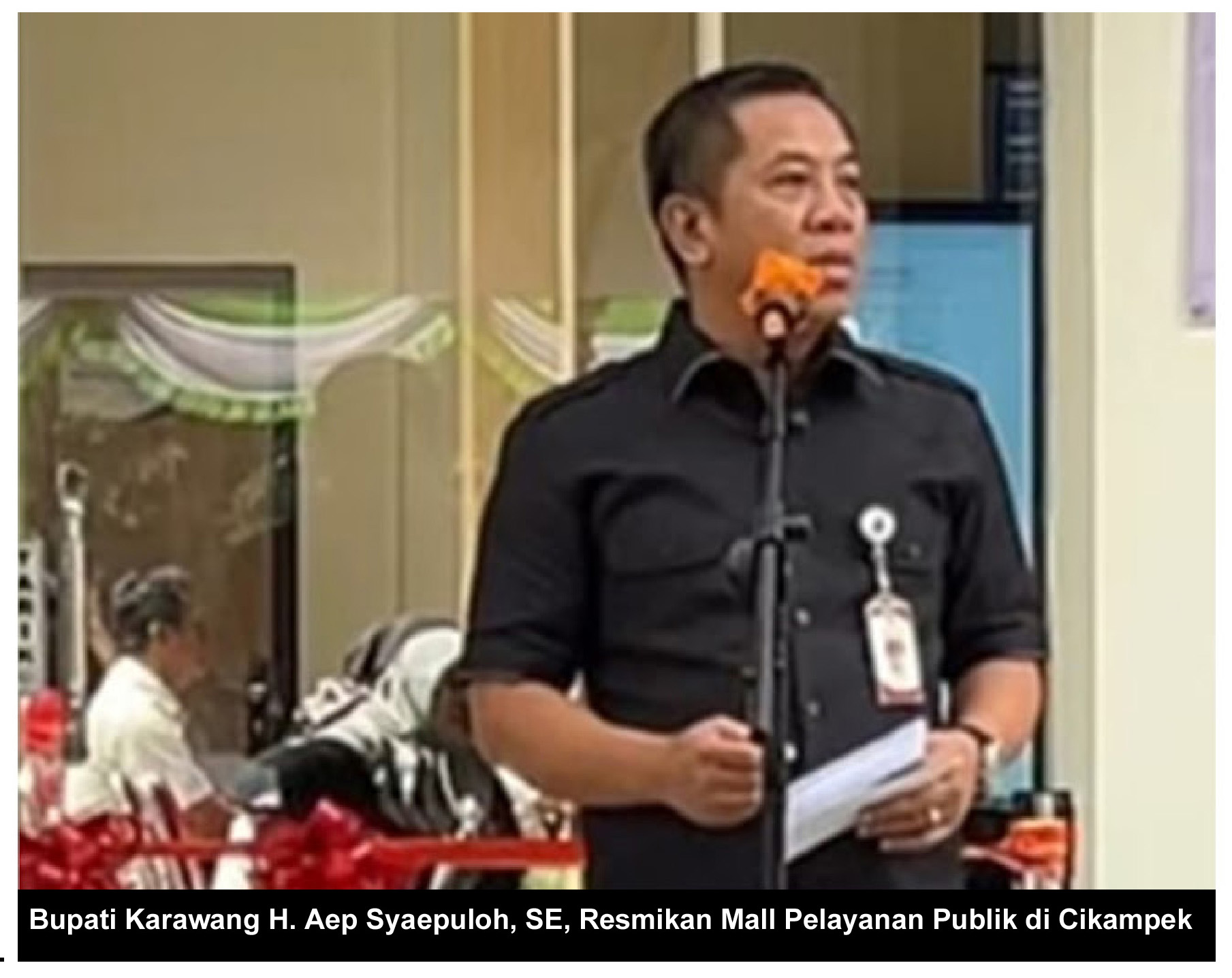 Man speaking at public event.